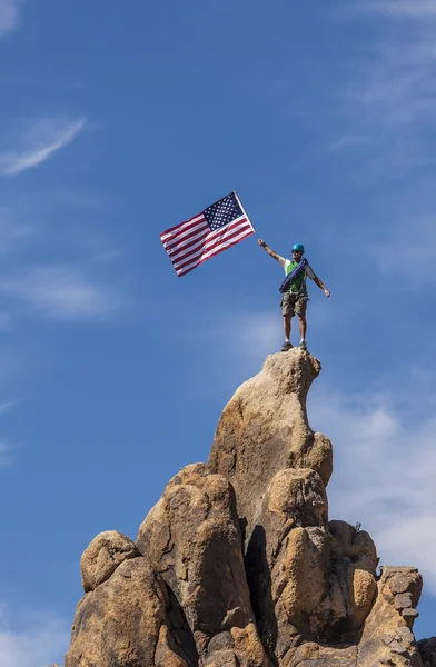 Waving a flag on the summit. — Stock Photo, Image