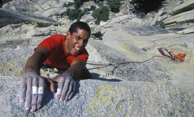 Climber clinging to a cliff. clipart