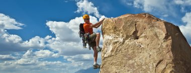 Rock climber nearing the summit. clipart