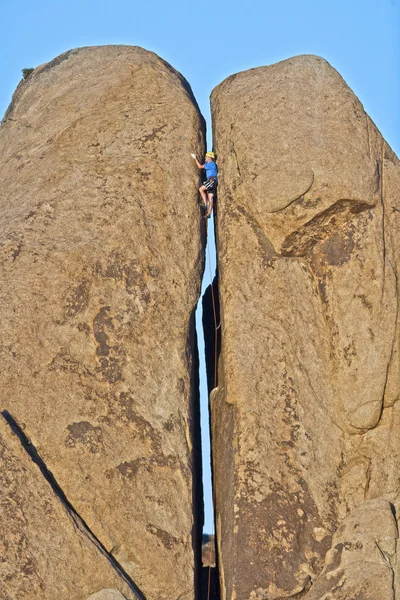 stock image Rock climber in a crack.