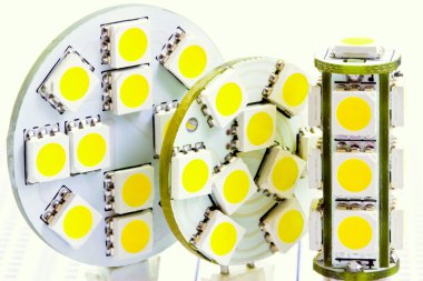 Two flat LED bulbs and one cylindrical LED bulb G4 clipart