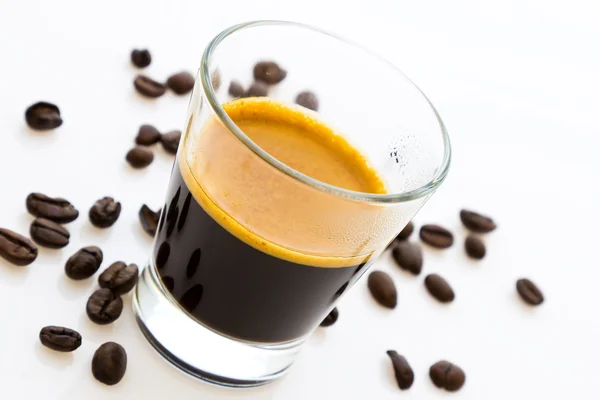 Hot espresso coffee with some coffee beans — Stock Photo, Image