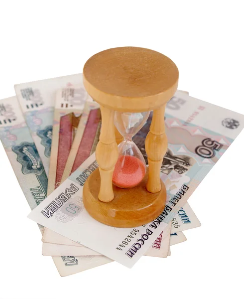 The sand-glass standing on money. Time is money. — Stock Photo, Image