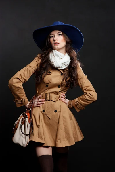 Woman wearing brown overcoat and cap blue — Stock Photo, Image