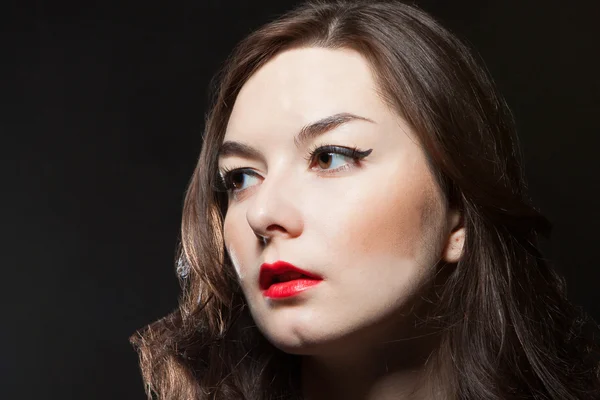 stock image Portrait of young woman on dark background