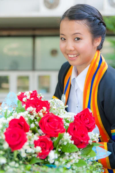 Stock image Graduated girl with red rose