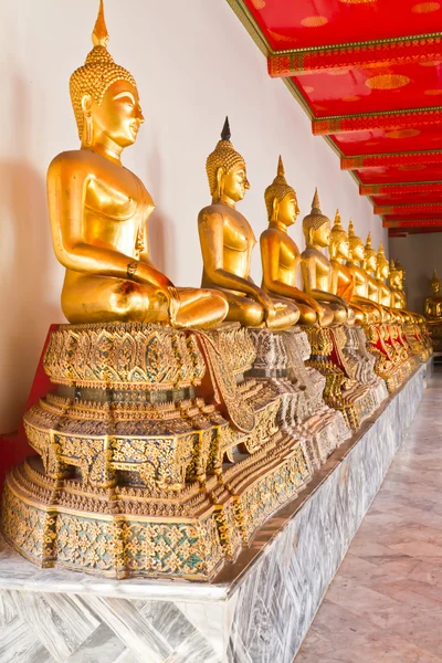 Golden sentado estátua de Buda em linha — Fotografia de Stock