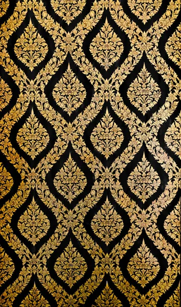 Golden Thai pattern on black wall — Stock Photo, Image