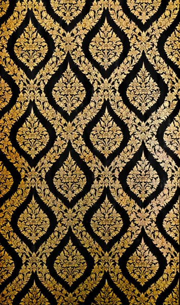 Golden Thai pattern on black wall — Stock Photo, Image