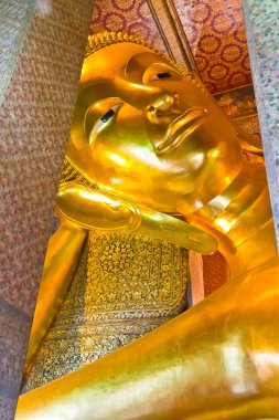 Face of reclining Buddha statue clipart