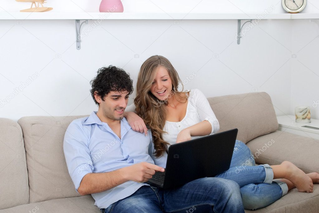 Young couple watching something on a laptop