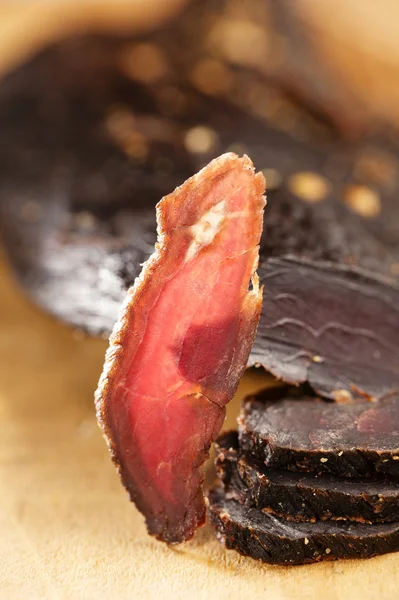Biltong - dry cured beef meat , backlit slice — Stock Photo, Image
