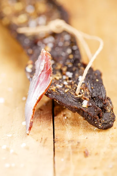 Biltong - dry cured beef meat , with slice — Stock Photo, Image