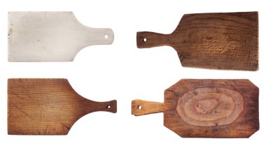 Four old used chopping kitchen boards, isolated over white clipart