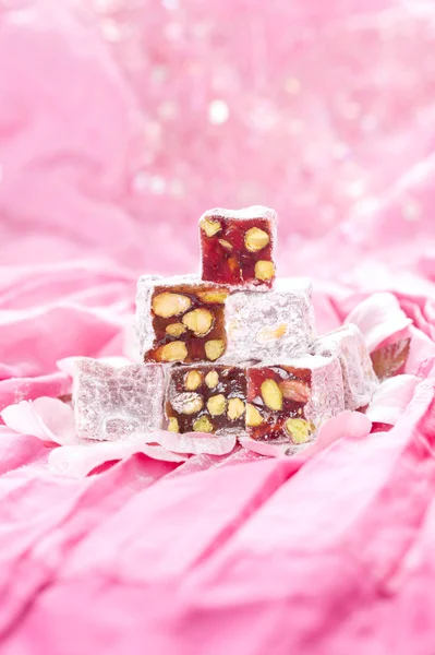 Turkish delight with pistachios nut in glitter pink and rose pe — Stock Photo, Image