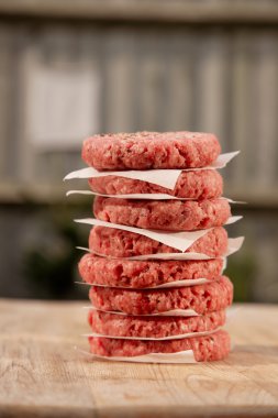 Raw burgers for hamburgers, in a pile clipart