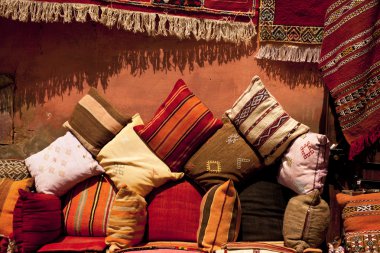 Moroccan cushions in a street shop in medina souk clipart