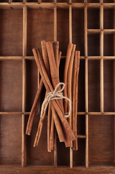 Palitos de canela en una vieja caja de madera — Foto de Stock