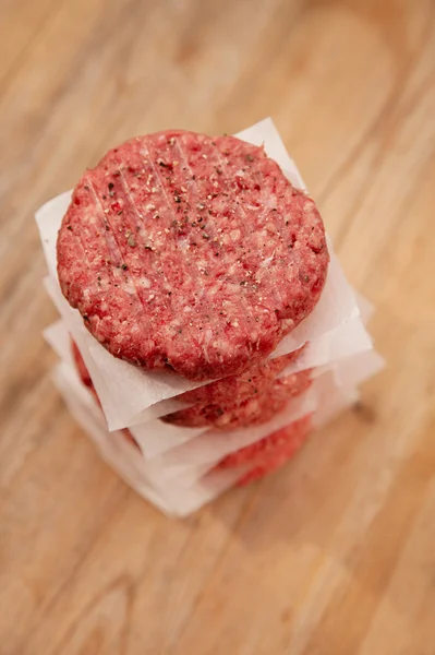 Raw burgers for hamburgers, in a pile — Stock Photo, Image
