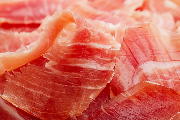 Spanish Serrano Ham Jamon sliced closeup background — Stock Photo, Image