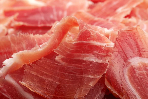 Spaanse serrano ham jamon gesneden close-up achtergrond — Stockfoto