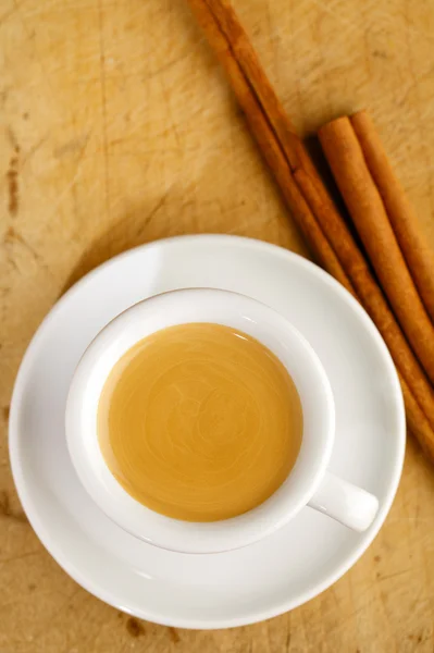 Caffè espresso in spessa tazza bianca con bastoncini di cannella, su woo — Foto Stock