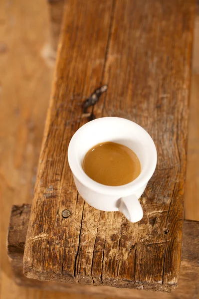 Espresso coffee in thick white cup on old wooden bench — Stock Photo, Image