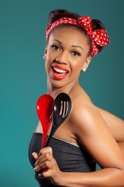 Beautiful happy joyful pinup style housewife with kitchen utensi clipart