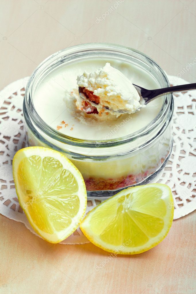 Lemon cheesecake in glass jar, closeup shot