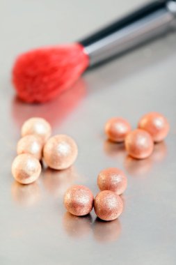 Closeup shot of three tone blusher balls with a brush clipart