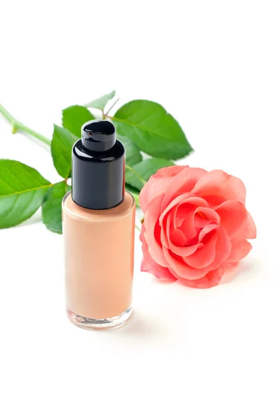 Closeup shot of foundation cream with a flower, on white — Stock Photo, Image