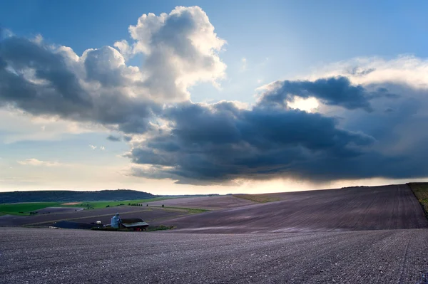 Stunning landscape with stormy sky over rural hills — Stock Photo, Image