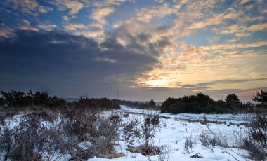 Vibrant Winter sunrise landscape over snow covered countryside