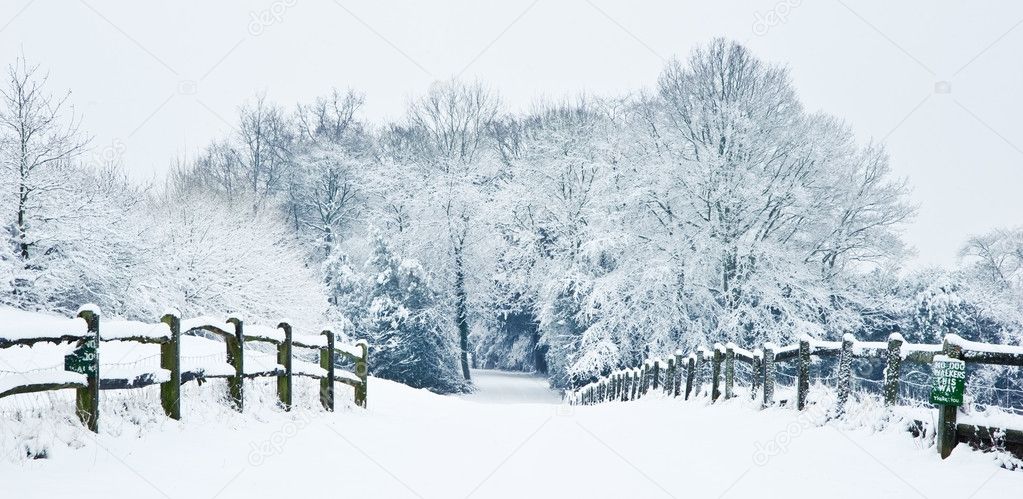 Path through English rural countryside in Winter with snow