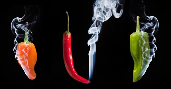 Red green and orange hot chilli peppers with smoke coming out of — Stock Photo, Image
