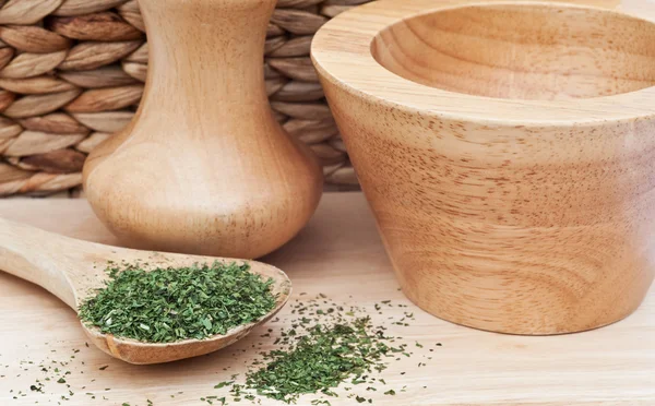 Chopped coriander cilantro leaves in rustic kitchen setting with — Stock Photo, Image