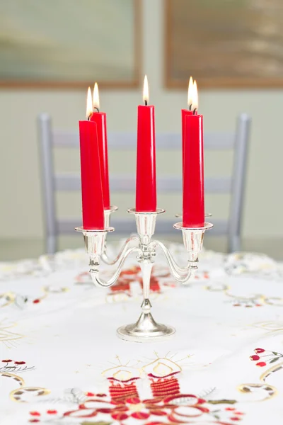 Candles in a candlestick on a table — Stock Photo, Image