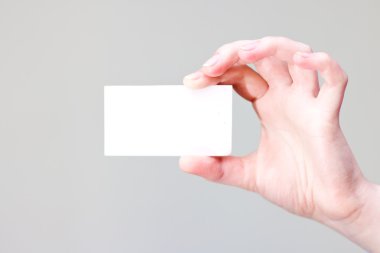 Arm holding businesscard with empty place for information and logo clipart