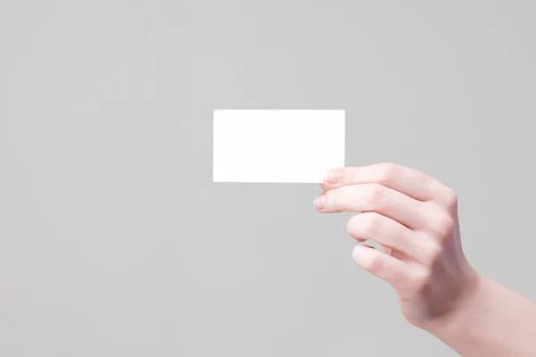 Arm holding businesscard with empty place for information and logo — Stock Photo, Image