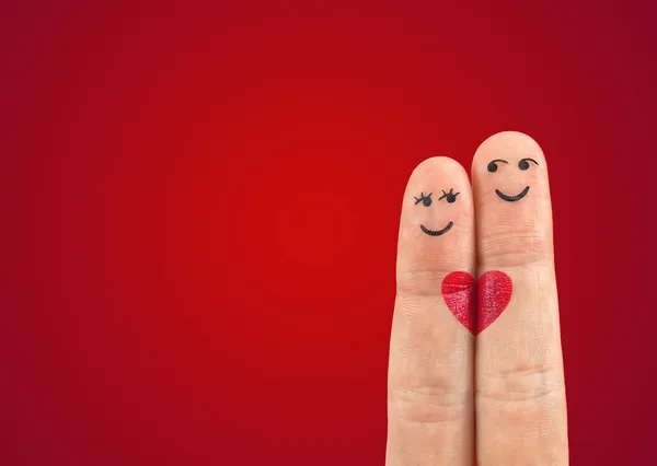 A happy couple in love with painted smiley and hugging — Stock Photo, Image