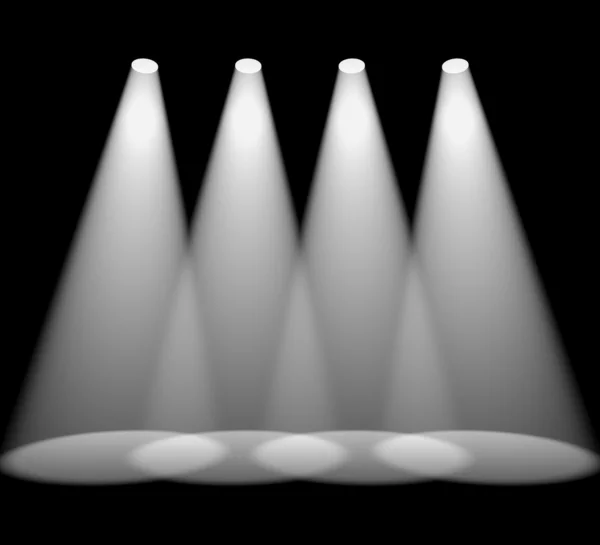 Quatre projecteurs blancs dans une rangée sur noir pour mettre en évidence le produit — Photo