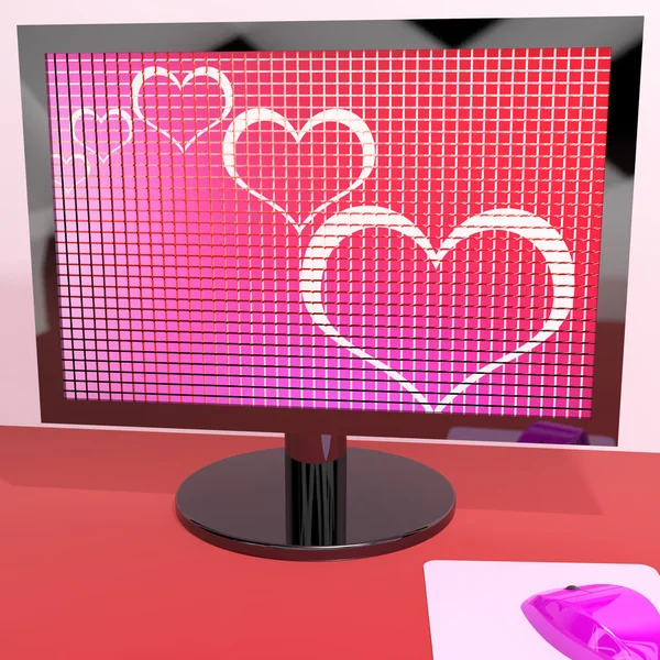 Corazones en la pantalla de la computadora que muestra amor y citas en línea —  Fotos de Stock