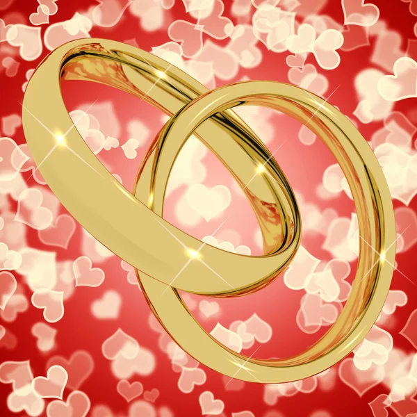 Anéis de ouro no fundo do coração Bokeh representando o amor Valentine — Fotografia de Stock
