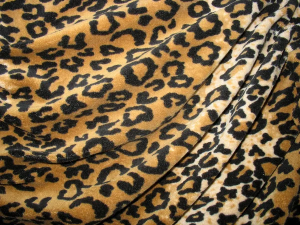 Fleecy brown draped leopard skin fabric — Stock Photo, Image