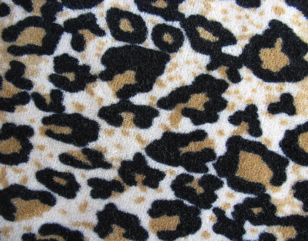 Fleecy white and brown leopard skin fabric background — Stock Photo, Image