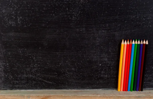 stock image Colorful pencils and board