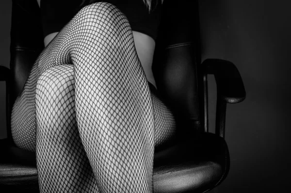 Girl in stockings sitting — Stock Photo, Image