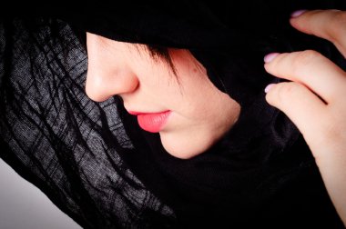 Part of a woman's face with black hood clipart