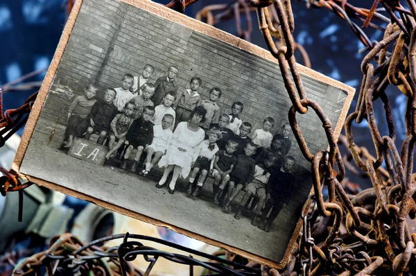 Stock image Photo of sad children in a group between rusty chains