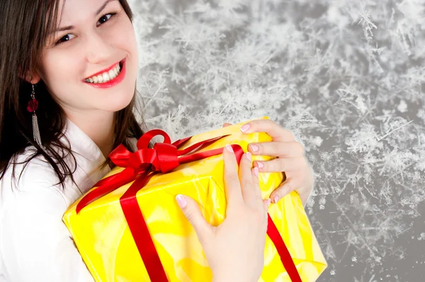 Cheerful girl holding present — Stock Photo, Image